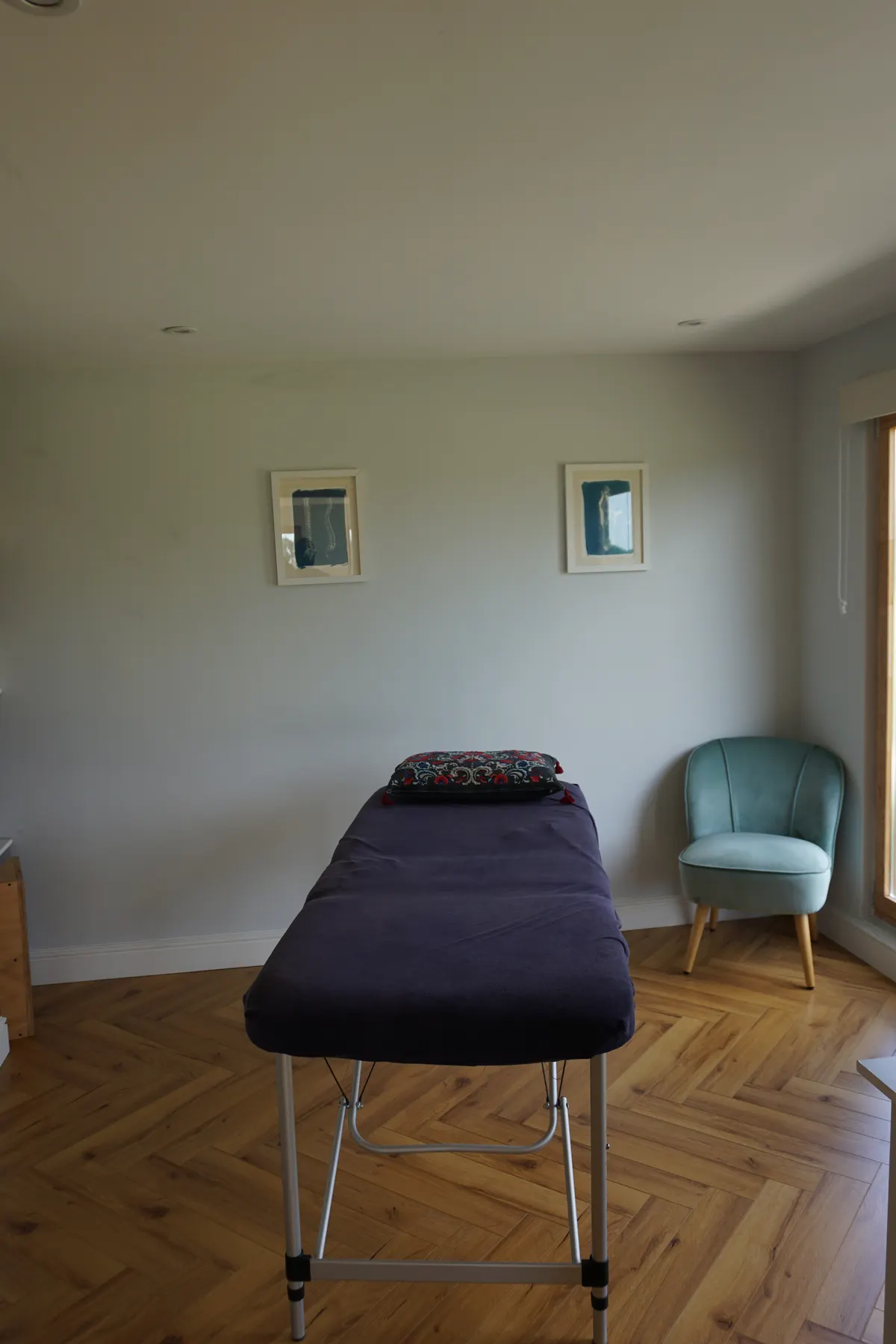 The calm, private treatment room with massage table and countryside view