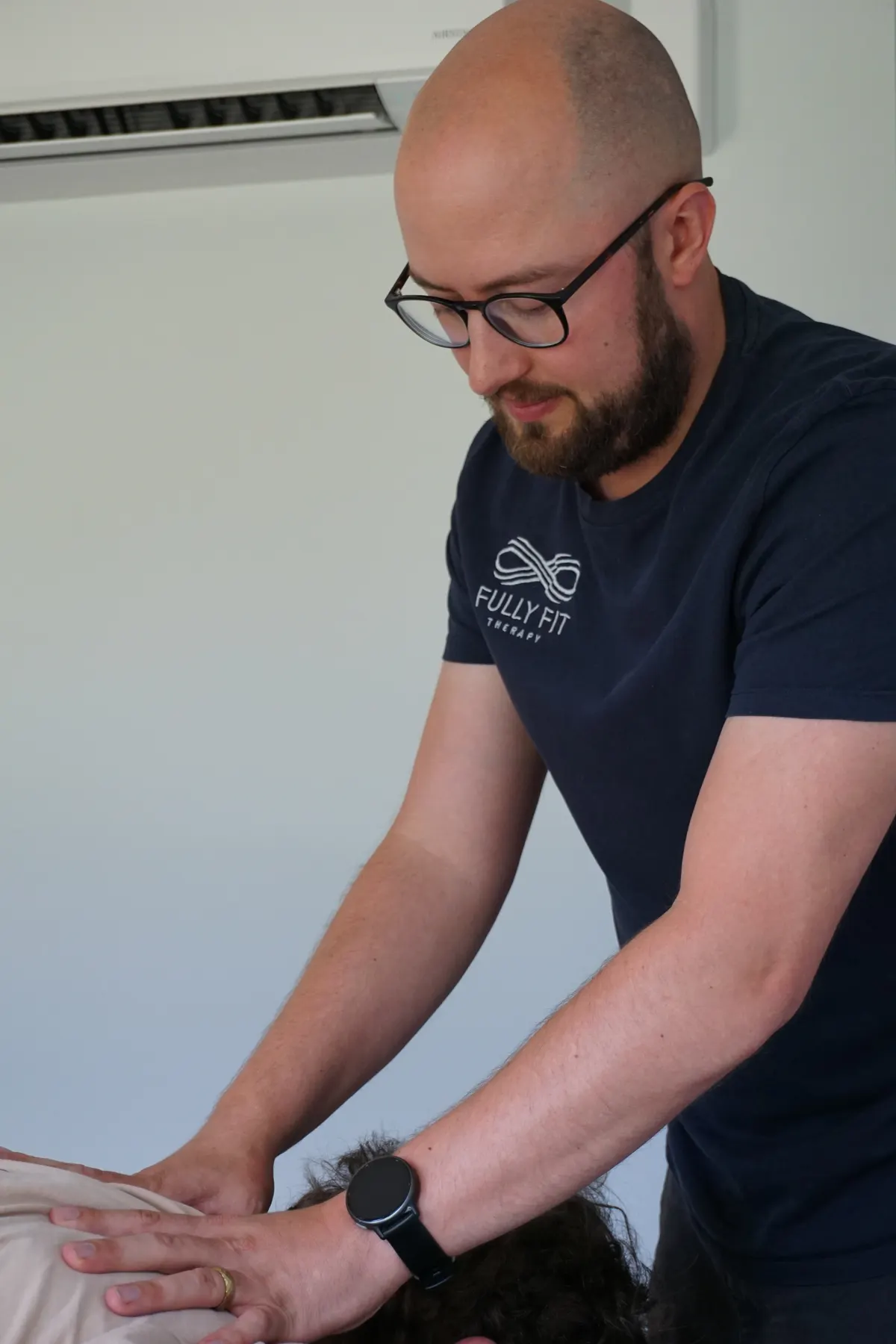 Deep-tissue sports massage to a client's back